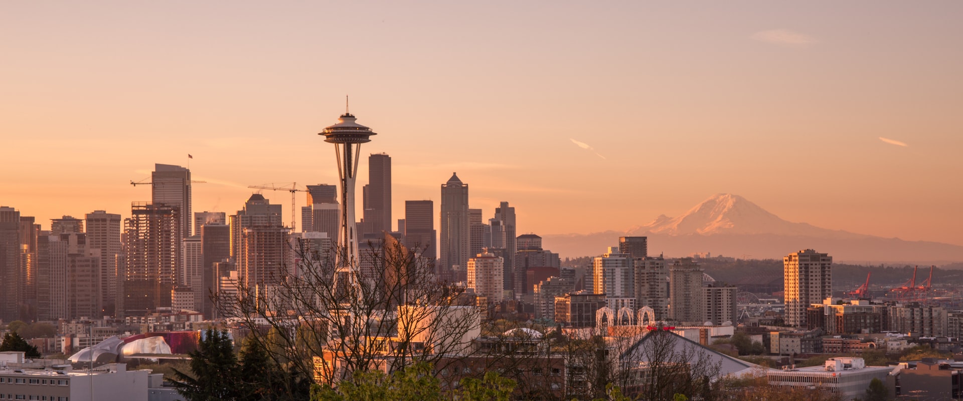 Aerial view of downtown Seattle from Elliott Bay, with the waterfront, ferries, and skyscrapers